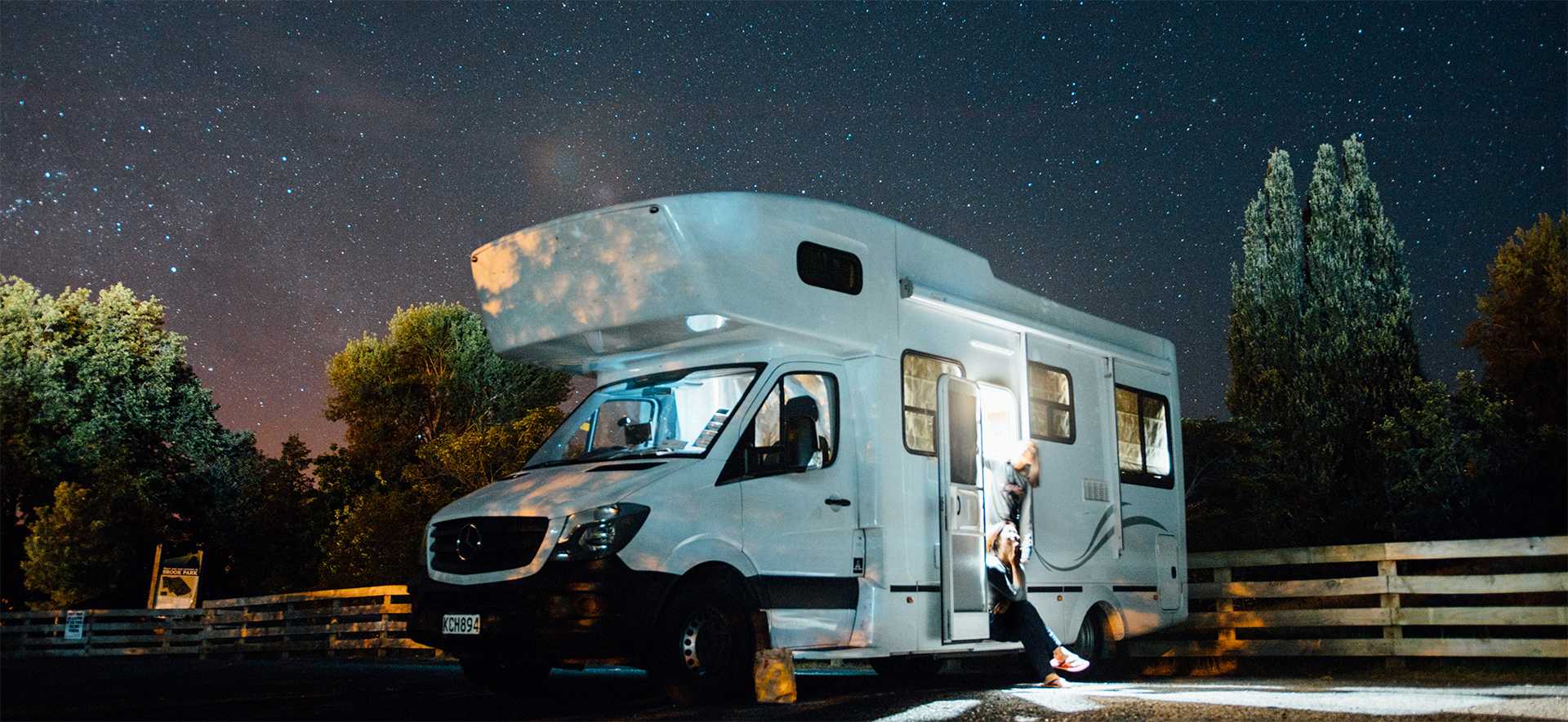 camper van under a night sky filled with stars